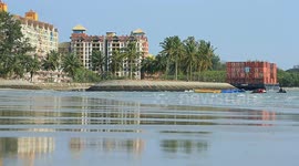 A container barge is stranded in Port Dickson waters near a resort hotel area after being swept away by sea waves following tropical Senyar