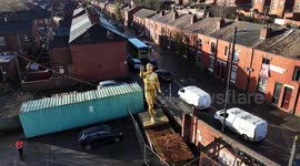 Controversial 20 foot golden nude statue reinstated after a campaign by locals