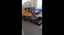 Mini-tractor damages multiple cars in yard area of Parnas in Saint Petersburg, Russia