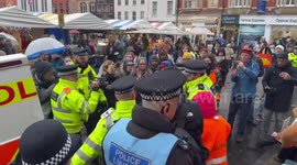 Police detain elderly demonstrators in Market Square in Cambridge, UK