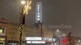 Enchanting nighttime snowfall blankets city streets in Minneapolis, USA