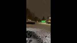 Steady snowfall blankets neighborhood in Michigan, USA