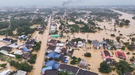 Rescue team evacuates bedridden villager and toddler stranded in flooded house