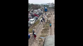 Locals loot beer from cargo train stranded during Thailand floods