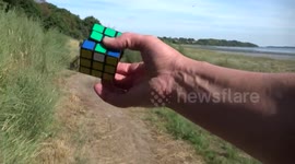 One Handed Rubik's Cube Solving While Riding a Mountain Bike