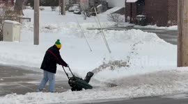 Clearing heavy snow from the roadway in Highland, Indiana, USA