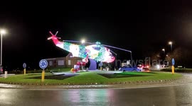 Impressive Christmas decorations, helicopter with Santa Claus in it at a busy traffic intersection
