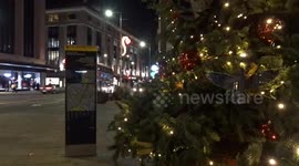 Kensington Christmas Tree shines outside St Mary Abbots Church on Kensington High Street in London