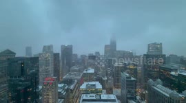 Snow-covered cityscape under heavy fog in Highland, Indiana, USA