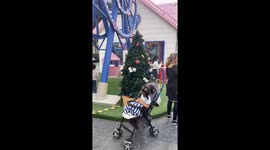 Locals play in artificial snow at Christmas display in tropical Thailand