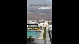 Massive dust storm engulfs Arizona neighborhood while resident continues swimming in pool
