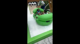Dad and daughter flip over on water slide after he gets scared and lets go of tube