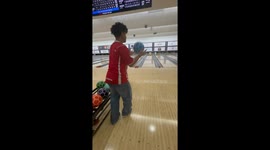 Bowler uses football skills to kick ball down lane for impressive strike in Singapore