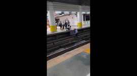 Kind station guards retrieve dropped phone from track