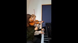 Two Women Simultaneously Playing Two Instruments Together