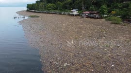 Debris washes ashore at Lake Singkarak following flash floods in Indonesia