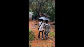 Friends slip and fall on muddy slope in Sidoarjo, Java, Indonesia