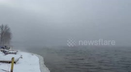 US: Ghostly Steam Lifts Off Frozen Lake In Winter Dawn