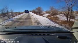 Truck driver reverses to regain control after sudden skid on snowy road