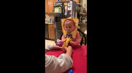 Toddler gets whipped cream in the face during Pie Face game in Magnolia, USA