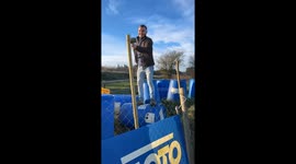 Worker slips while hammering on rolling container in Falaise, France