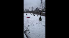 Daughter enjoys snow sliding fun in the backyard in Florence, Kentucky, USA