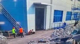 Bungling forklift driver drops metal cages onto workers