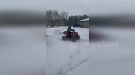 US: ATV Powers Through Snow As Sled Rider Races Behind In Mooresville Driveway