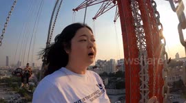 Thai woman terrified as she faces her fear of heights on 435ft high swing in Bangkok