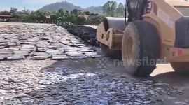 Bulldozer crushes hundreds of laptops and phones seized from scam centres in Myanmar