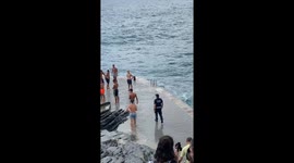 Huge wave crashes over group of friends on pier in Vernazza, Italy
