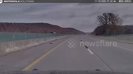 Police patrol car dodges three loose tyres flying from truck