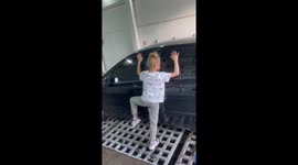 Girl leaves perfect silhouette on car after being sprayed with foam at Russian car wash
