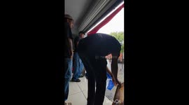 Mischievous worker dumps gallons of rainwater on friend from shop canopy