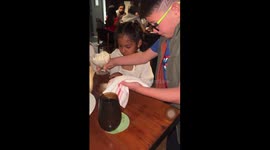 Dad reacts as his daughter makes a new friend at dinner in Cancún, Mexico