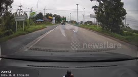 Plastic container falls from truck and gets stuck under car travelling behind