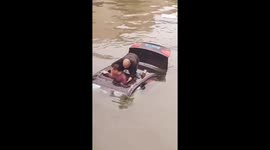 Heroic stranger jumps into river and performs CPR on sinking car's roof to save unconscious driver