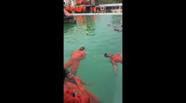 Seafarers undergo deepwater survival training in swimming pool