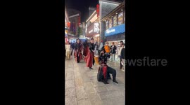 Staff dress as 'imperial guards' to patrol streets and pick up litter in China