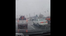 Crash on a snowy wet morning, car crosses traffic and flips into a pole.
