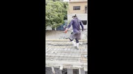 Workers Perform Stylish Flips Off Roof