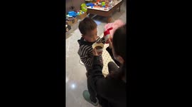 Young boy proudly drinks his medicine in Hubei, China