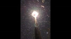 Gentle winter snowfall glows under streetlight in Dayton, Virginia, USA