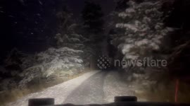 Snowplow navigates heavy winter roads in Evergreen, Colorado, USA