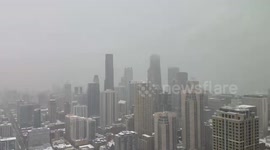 Heavy snowfall blankets rooftops and skyline in Highland, Indiana, USA
