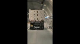 Puzzle-like truck lights reflect beautifully inside tunnel in Guangxi, China