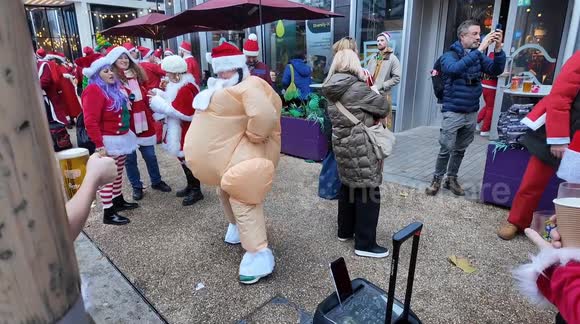 Santas having fun whilst drinking at the annual Santacon London