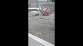 Motorist swept away by floodwaters on highway in Malang, Indonesia