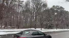 Light snowfall reduces visibility in Severn, Maryland, USA