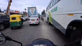 Bus narrowly avoids hitting motorcyclist in Bangalore, India